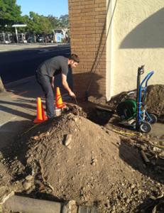 Plumber in McKinney TX removes drain from roadside commercila clog